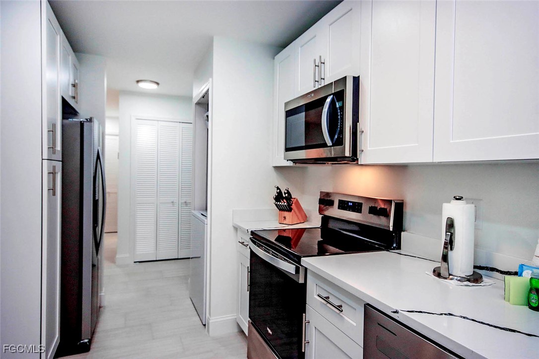 5117 Sea Bell Road, Unit A102 Sanibel, FL 33957 - Photo 11 of 21 a kitchen with a stove and a refrigerator