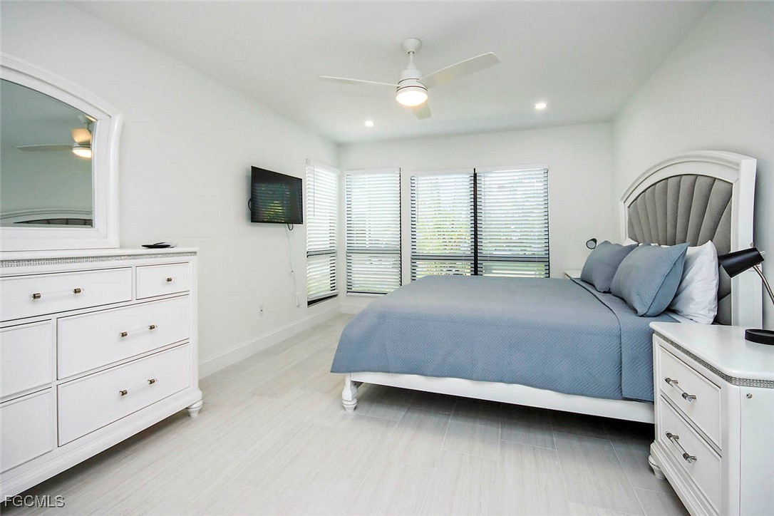 5117 Sea Bell Road, Unit A102 Sanibel, FL 33957 - Photo 13 of 21 a bedroom with a bed and a flat screen tv