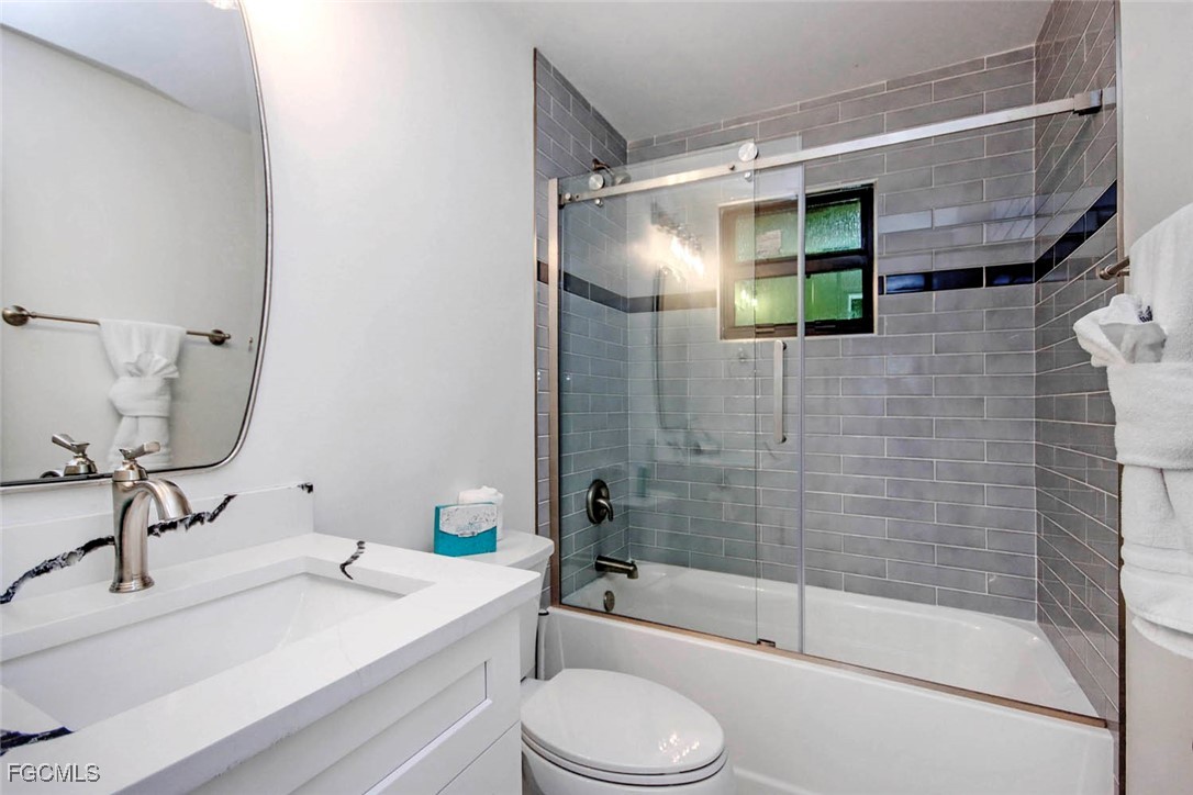 5117 Sea Bell Road, Unit A102 Sanibel, FL 33957 - Photo 14 of 21 a bathroom with a sink toilet and shower