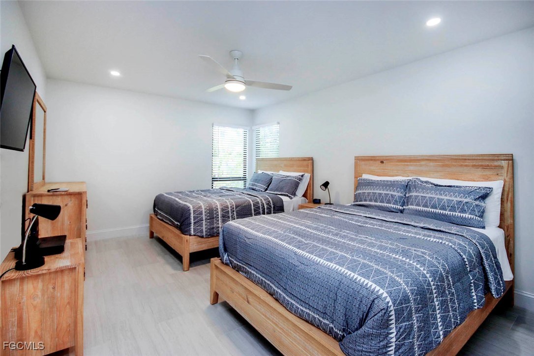 5117 Sea Bell Road, Unit A102 Sanibel, FL 33957 - Photo 15 of 21 a bedroom with two beds and a flat screen tv