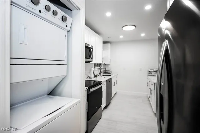a kitchen with a refrigerator sink stove and cabinets