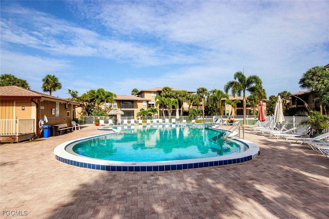 5117 Sea Bell Road, Unit A102 Sanibel, FL 33957 - Photo 20 of 21 a swimming pool with outdoor seating and yard