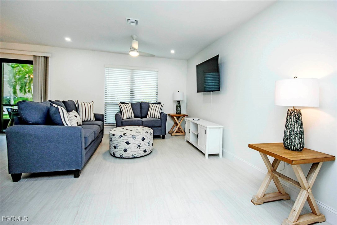 5117 Sea Bell Road, Unit A102 Sanibel, FL 33957 - Photo 4 of 21 a living room with furniture and a flat screen tv