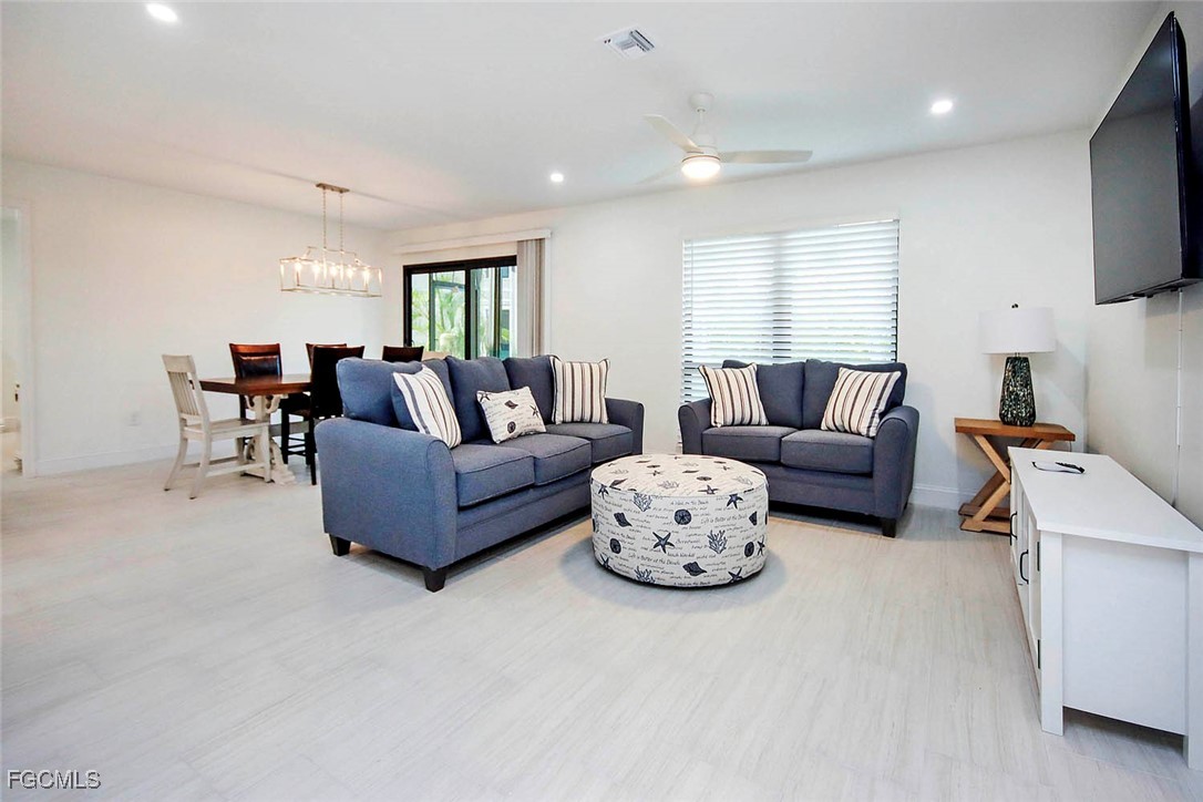 5117 Sea Bell Road, Unit A102 Sanibel, FL 33957 - Photo 5 of 21 a living room with furniture and a flat screen tv