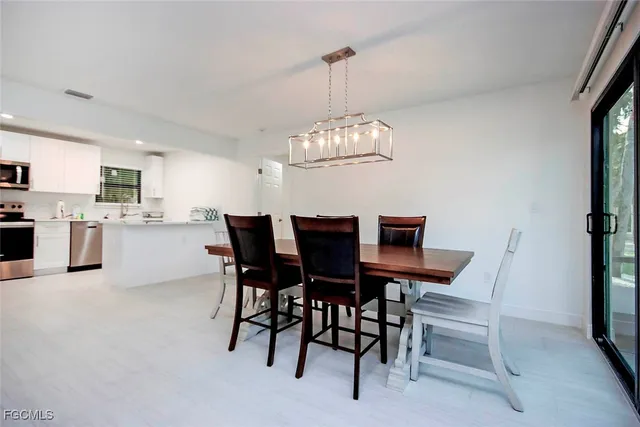 a view of a dining room with furniture and chandelier