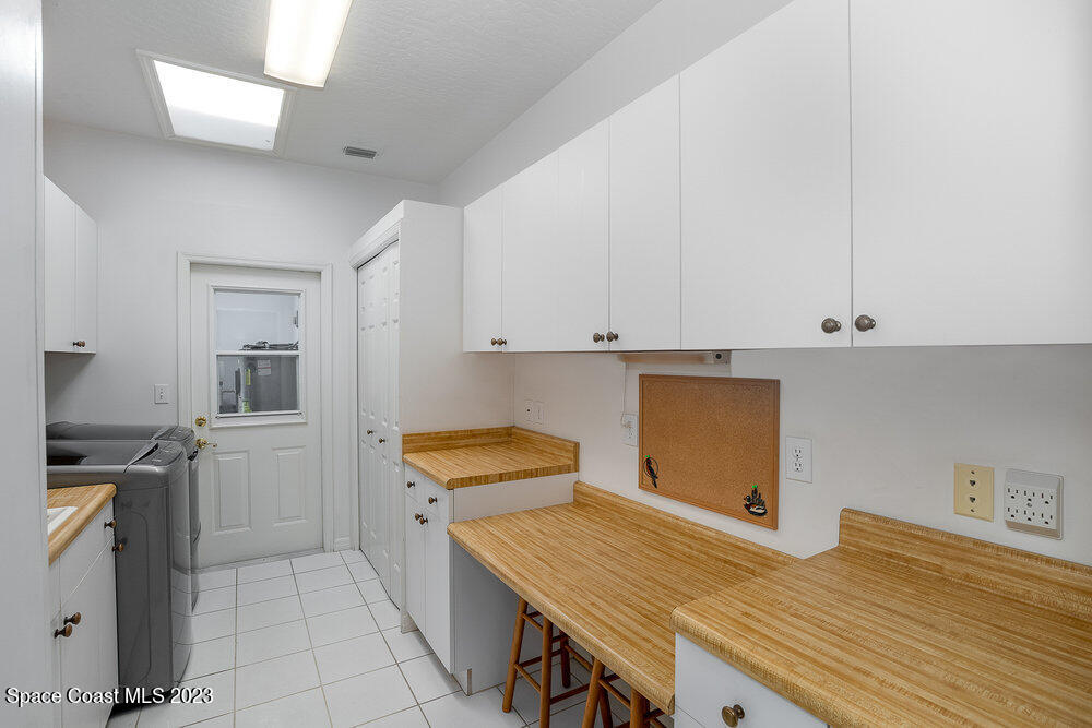 1800 Valkaria Road Malabar, FL 32950 - Photo 33 of 34 a bedroom with a bed and cabinets