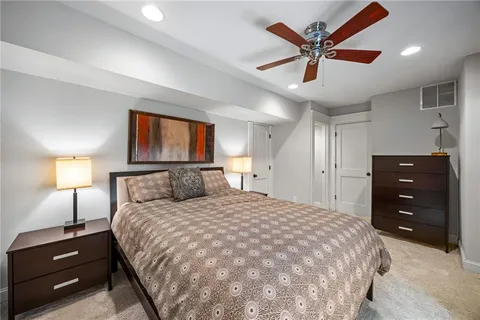 a bedroom with a bed and a mirror