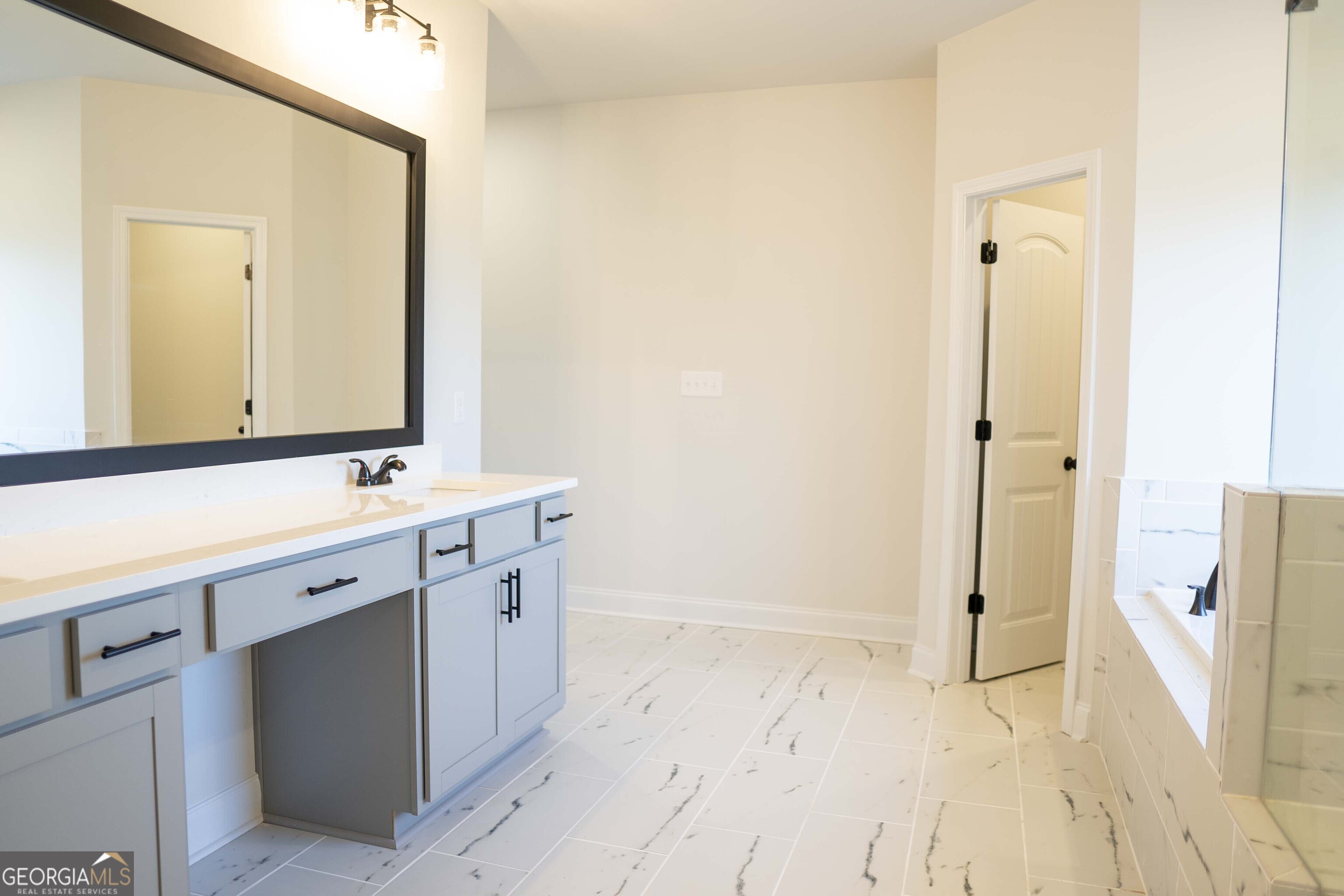600 Beaver Court Perry, GA 31069 - Photo 34 of 48 a spacious bathroom with a double vanity sink a mirror and a