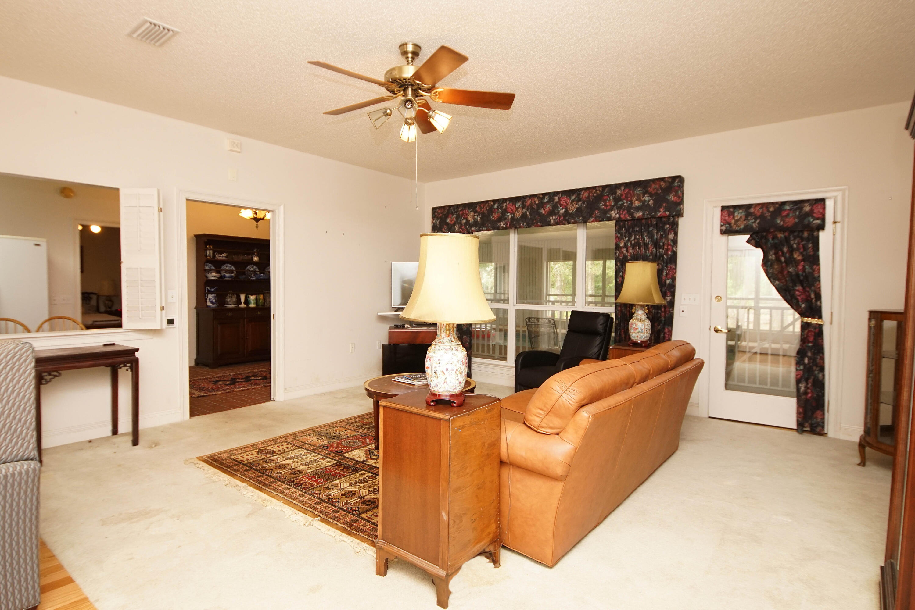 600 Northwest Mooney Road Fort Walton Beach, FL 32547 - Photo 12 of 35 a living room with furniture and a wooden floor