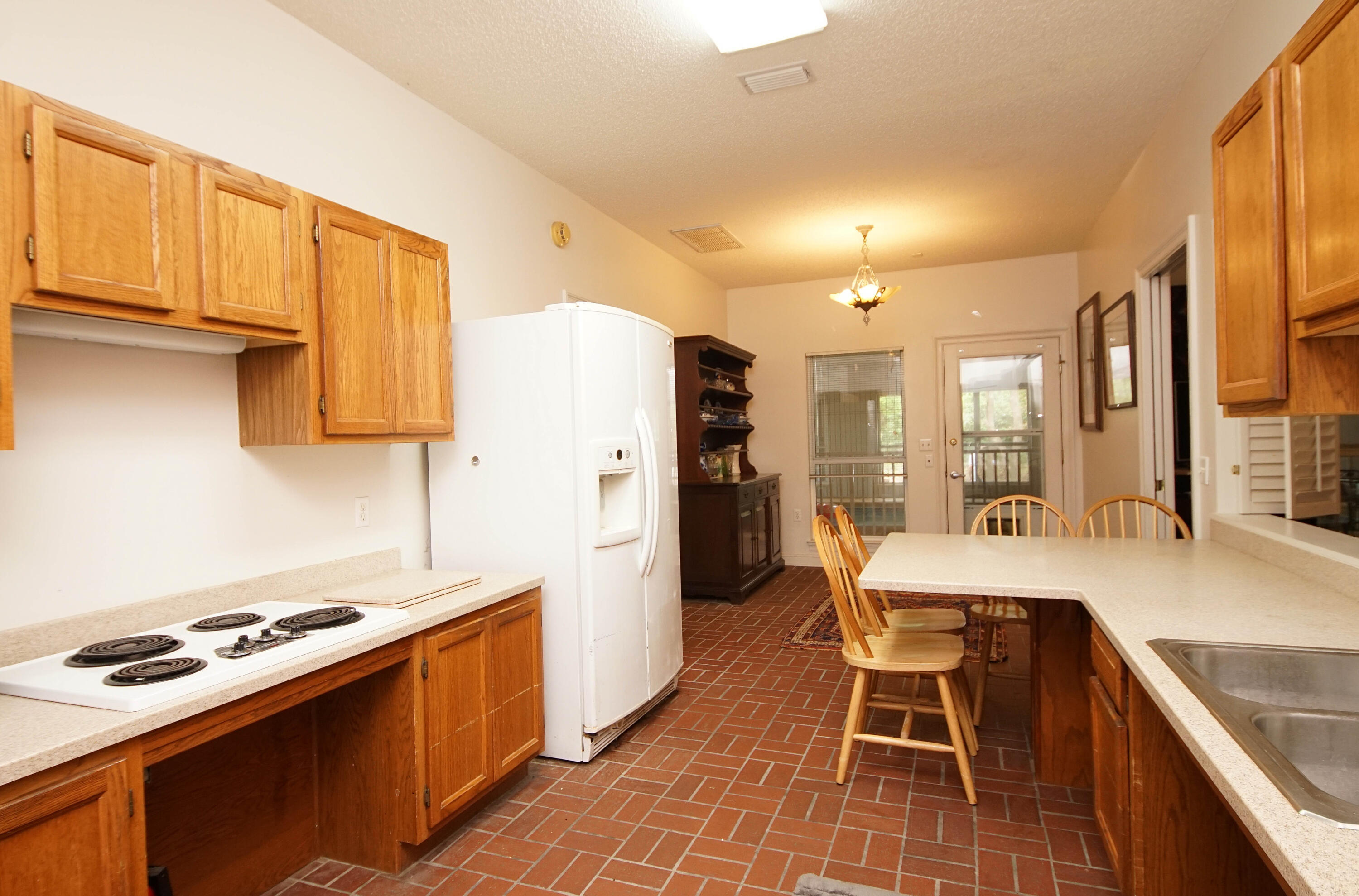 600 Northwest Mooney Road Fort Walton Beach, FL 32547 - Photo 14 of 35 a kitchen with stainless steel appliances granite countertop a stove a refrigerator a kitchen island and chairs in it