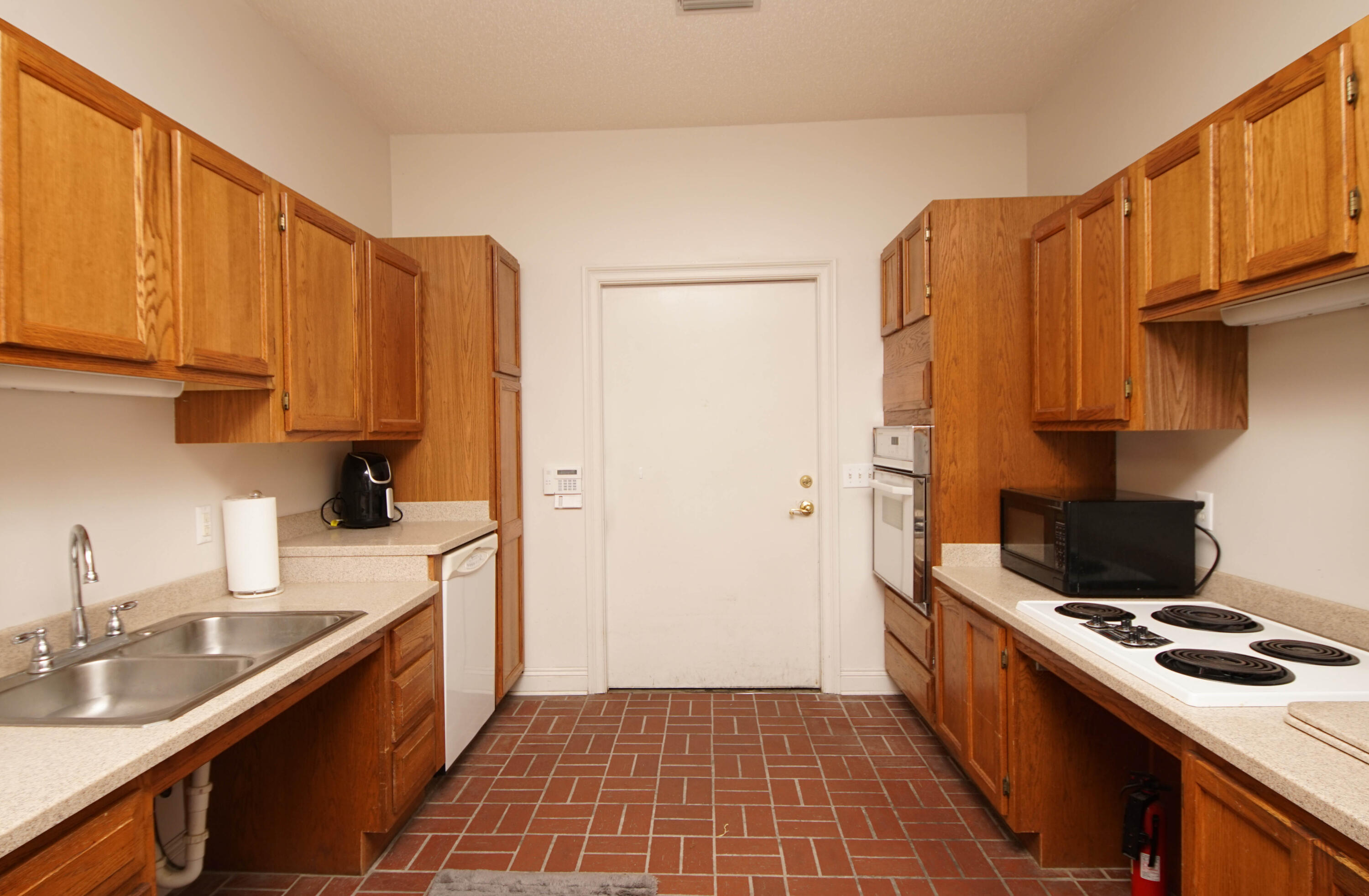 600 Northwest Mooney Road Fort Walton Beach, FL 32547 - Photo 16 of 35 a kitchen with a sink a stove and a refrigerator