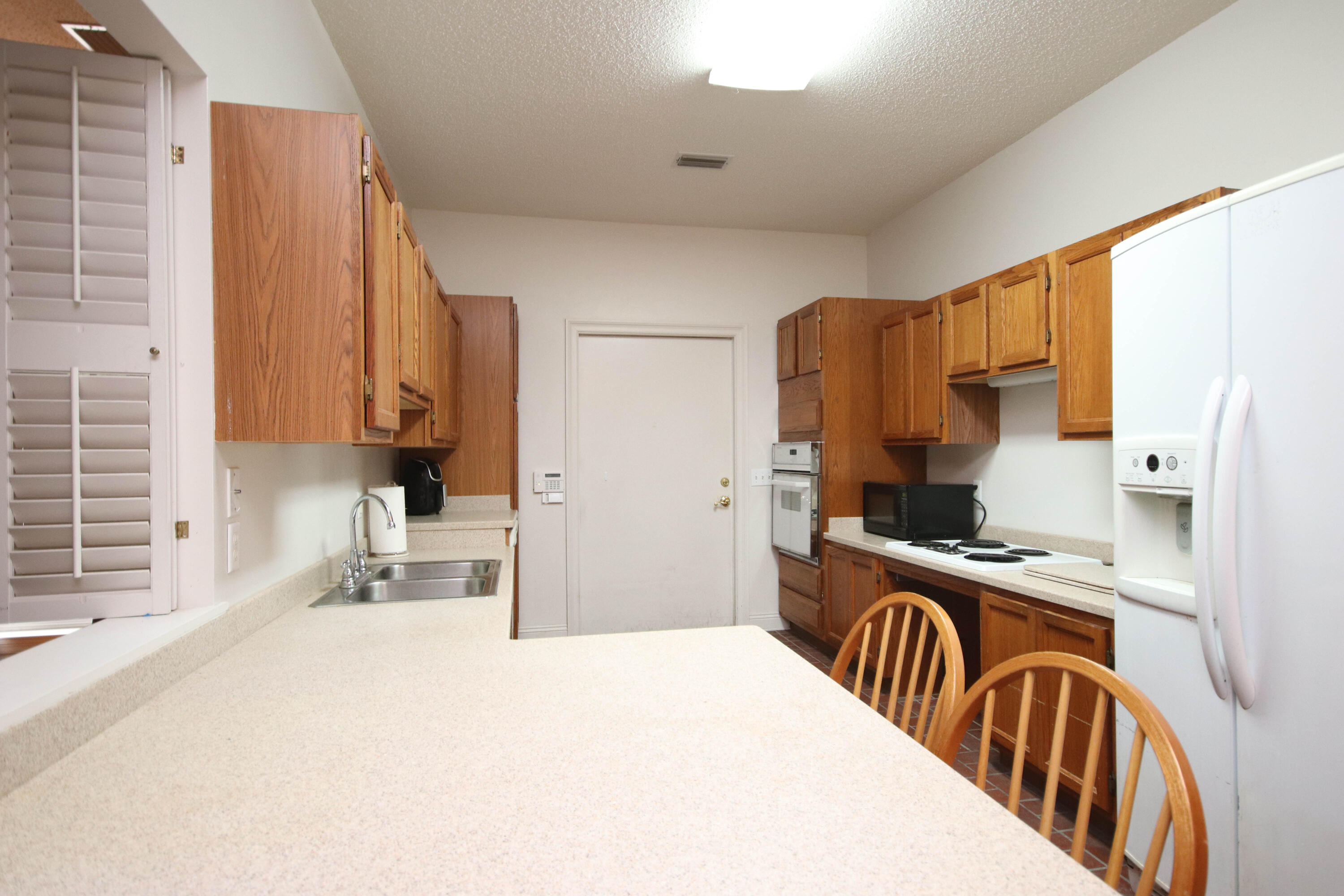 600 Northwest Mooney Road Fort Walton Beach, FL 32547 - Photo 17 of 35 a kitchen with stainless steel appliances kitchen island granite countertop a sink a stove and a refrigerator