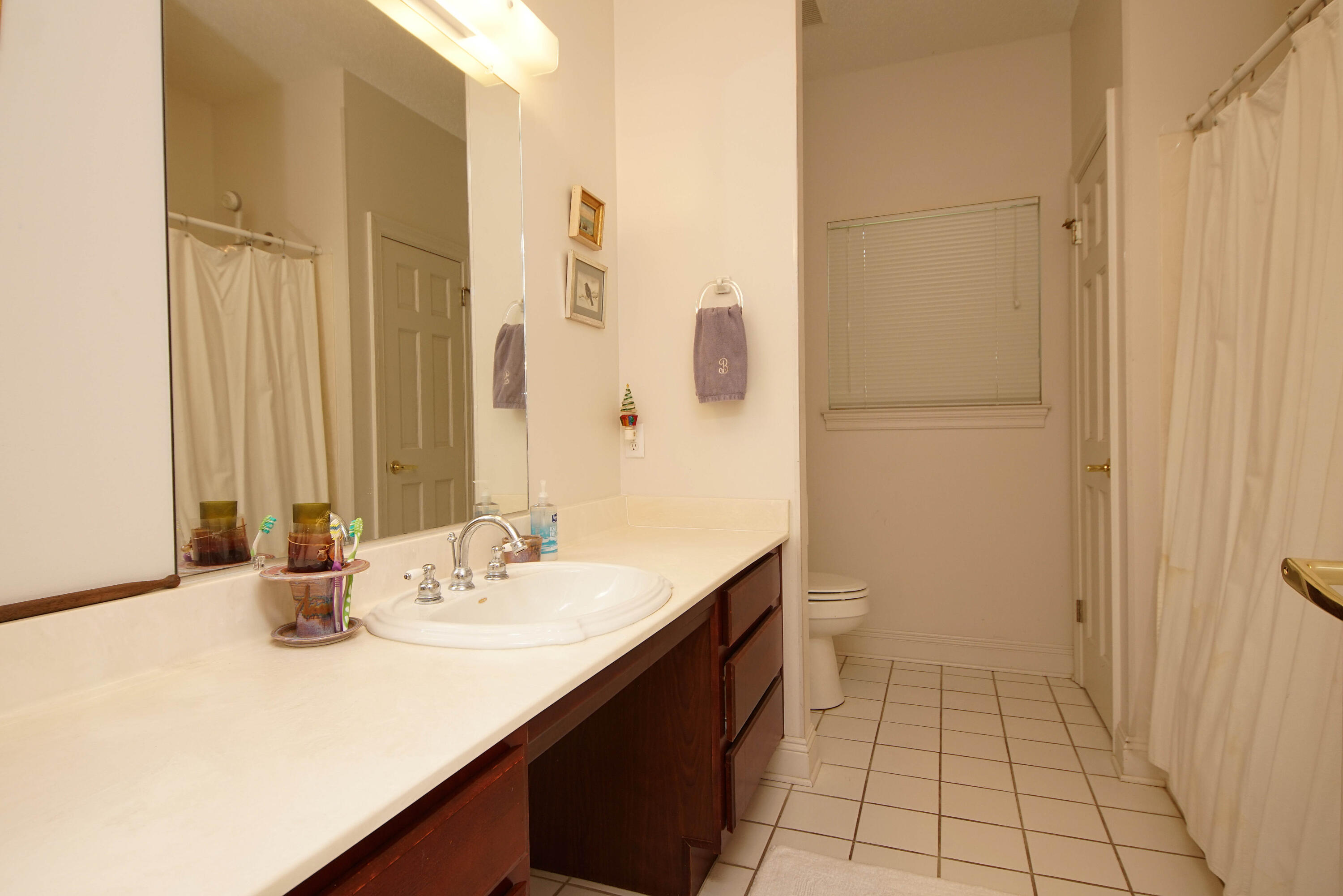 600 Northwest Mooney Road Fort Walton Beach, FL 32547 - Photo 26 of 35 a bathroom with a sink and a mirror