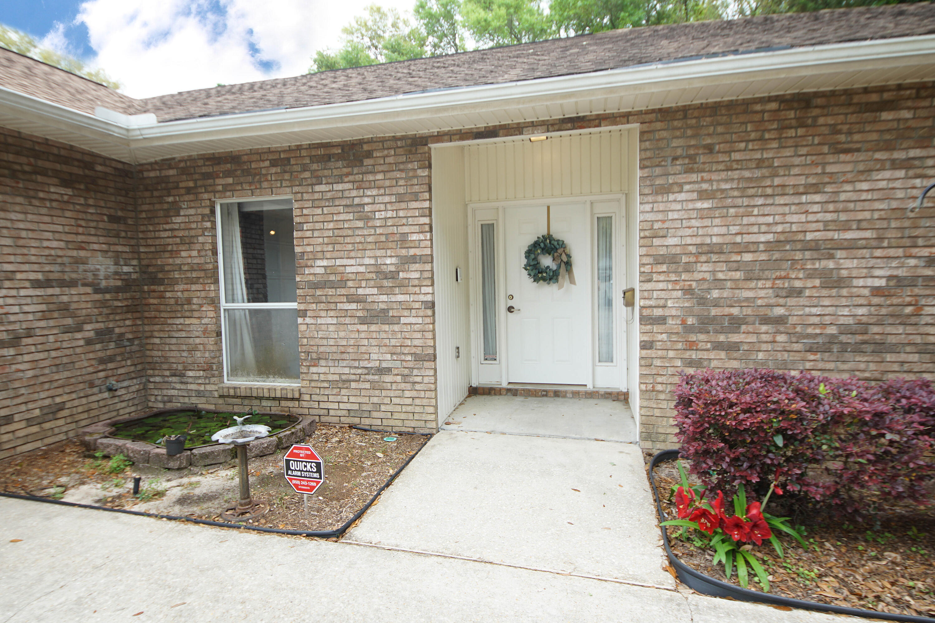600 Northwest Mooney Road Fort Walton Beach, FL 32547 - Photo 3 of 35 a front view of a house with a garden
