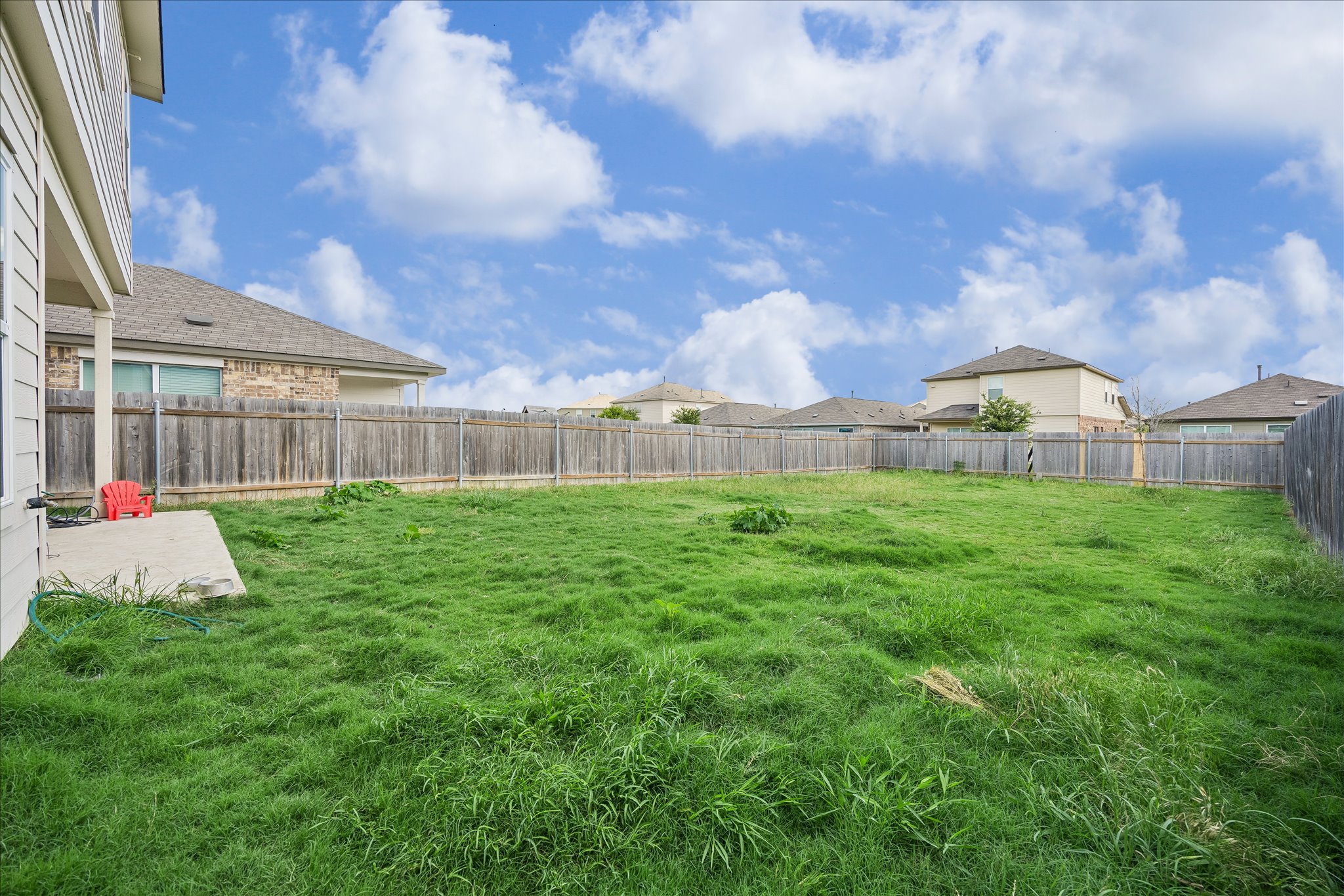 217 Canley Loop Hutto, TX 78634 - Photo 33 of 36 A spacious backyard enclosed by a wooden privacy fence offers ample room for outdoor activities.