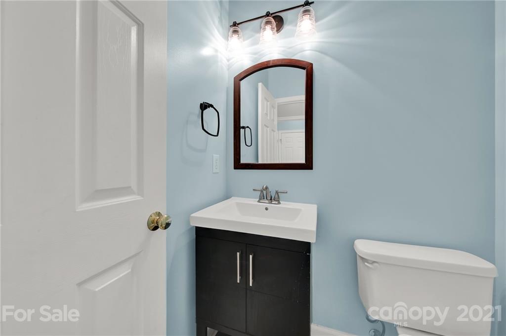 3307 Creek Trail Road Indian Trail, NC 28079 - Photo 16 of 43 a bathroom with a toilet sink vanity and mirror