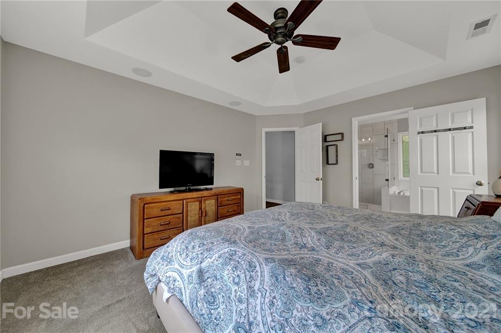 3307 Creek Trail Road Indian Trail, NC 28079 - Photo 21 of 43 a bedroom with a bed and a flat screen tv