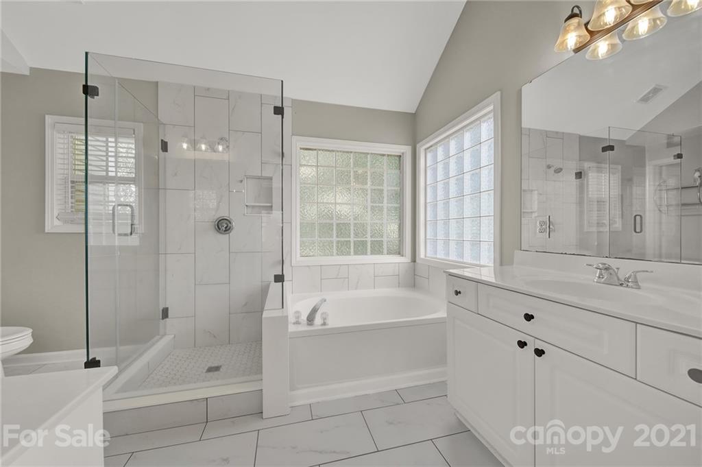 3307 Creek Trail Road Indian Trail, NC 28079 - Photo 22 of 43 a bathroom with a tub sink and mirror