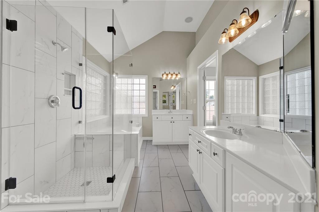 3307 Creek Trail Road Indian Trail, NC 28079 - Photo 23 of 43 a spacious bathroom with a shower sink and mirror