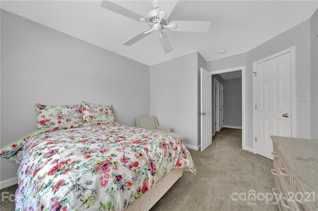 3307 Creek Trail Road Indian Trail, NC 28079 - Photo 26 of 43 a bedroom with a bed and a chandelier