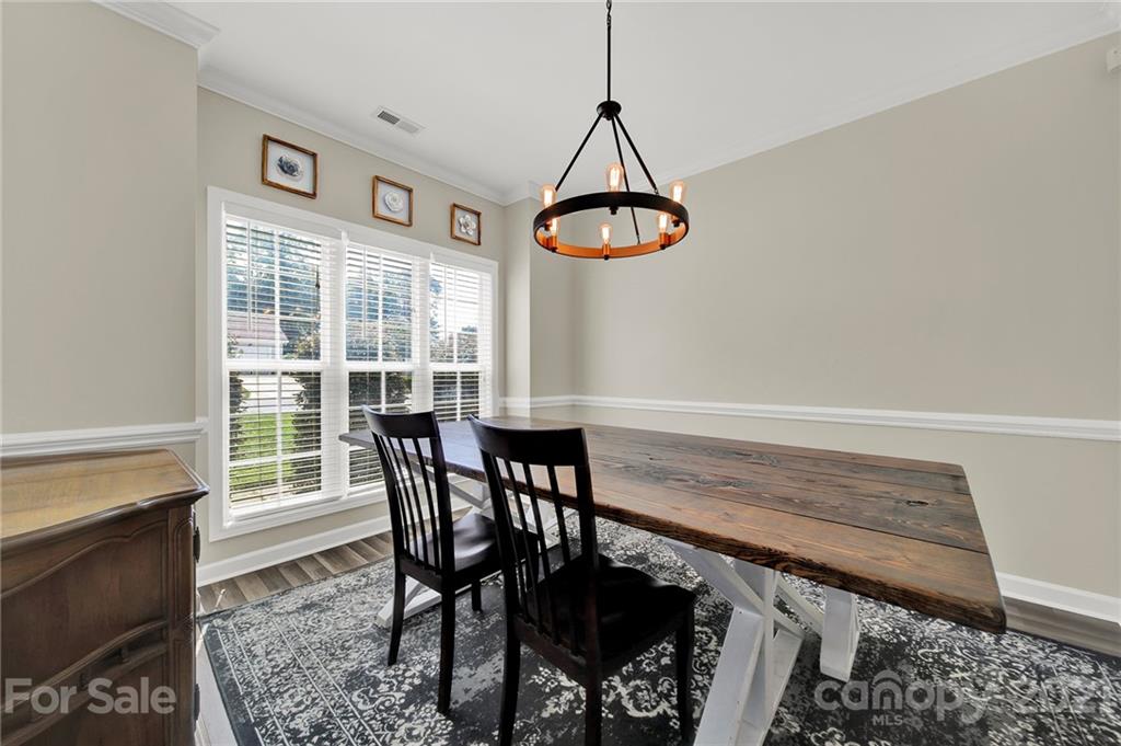 3307 Creek Trail Road Indian Trail, NC 28079 - Photo 5 of 43 a view of a dining room with furniture window and wooden floor