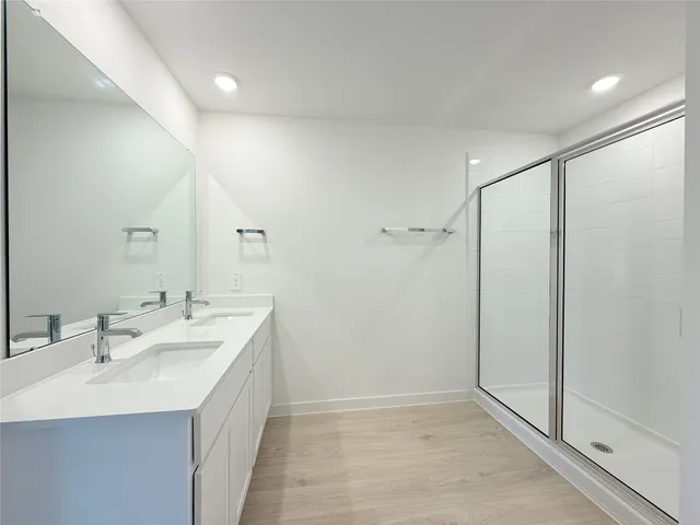 a bathroom with a double vanity sink and mirror