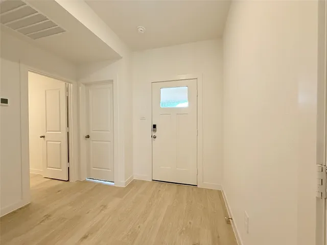 a view of an empty room and wooden floor