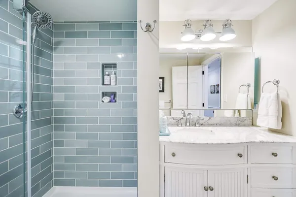 a bathroom with a double vanity sink mirror and