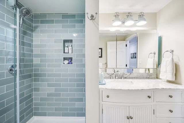 a bathroom with a double vanity sink mirror and