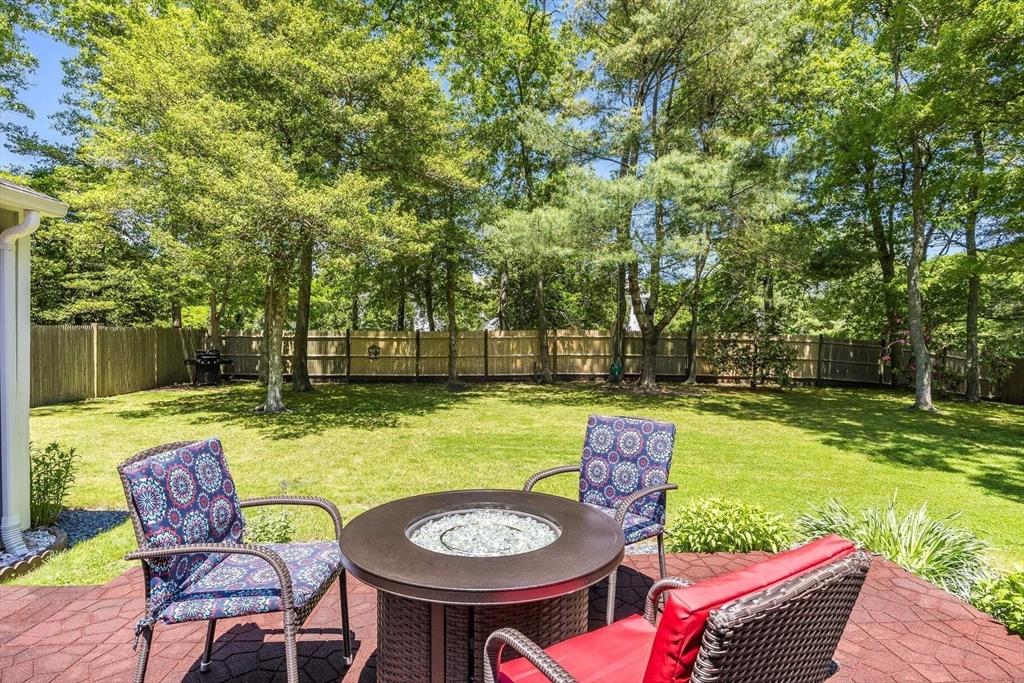 36 Sylvia Lane, Unit 36 Barnstable, MA 02632 - Photo 9 of 9 a backyard of a house with yard and outdoor seating