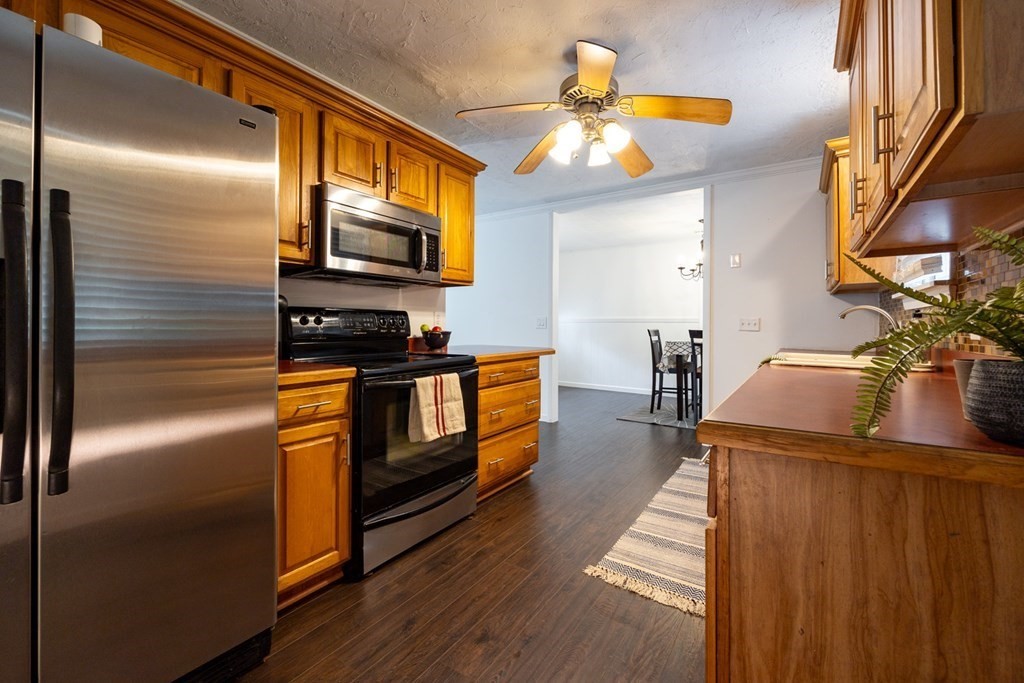 38 Ridge Street Westminster, MA 01473 - Photo 7 of 27 a kitchen with stainless steel appliances granite countertop a refrigerator a oven and a sink with wooden floor