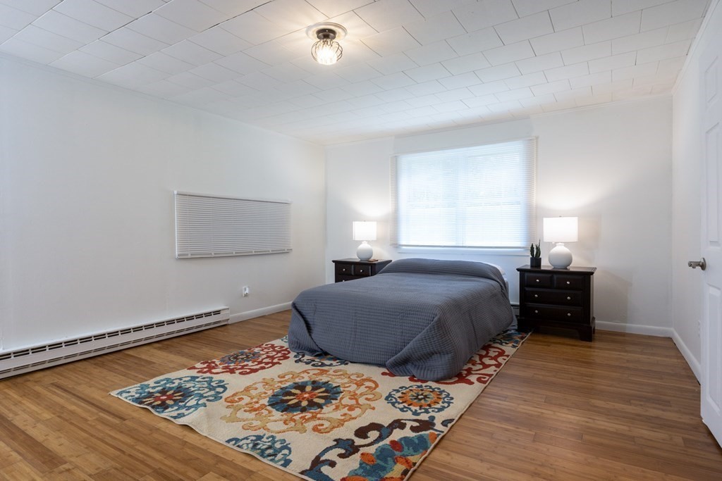 38 Ridge Street Westminster, MA 01473 - Photo 9 of 27 a bedroom with a bed and wooden floor