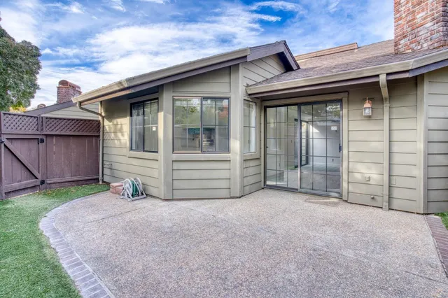 a swimming pool with outdoor seating and yard