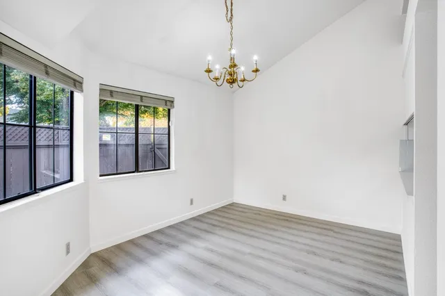a view of a kitchen with a refrigerator wooden floor and a kitchen