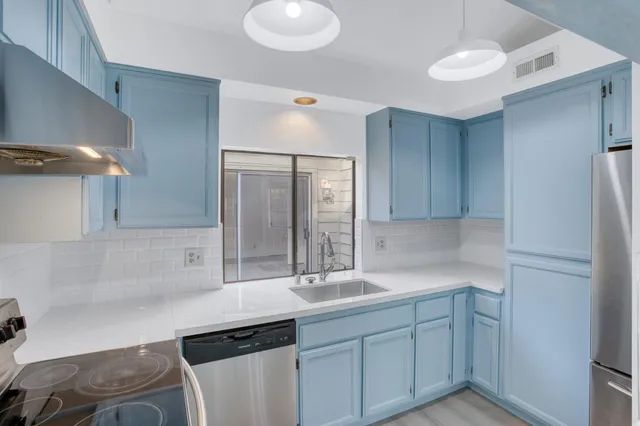 a stove top oven sitting inside of a kitchen