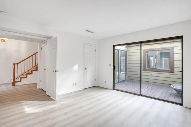 a view of a door and chair in the balcony with wooden floor