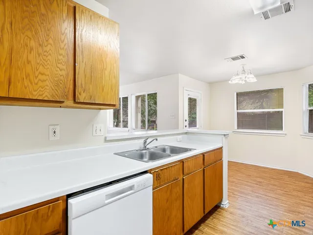 a kitchen with a sink and cabinets