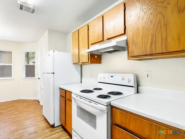 a kitchen with a stove and a refrigerator