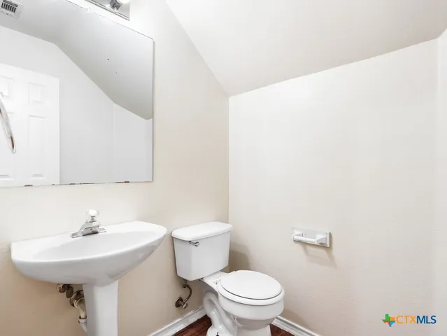 a bathroom with a sink a mirror and a toilet
