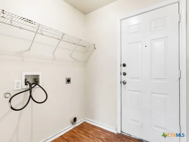 a view of a closet with wooden floor