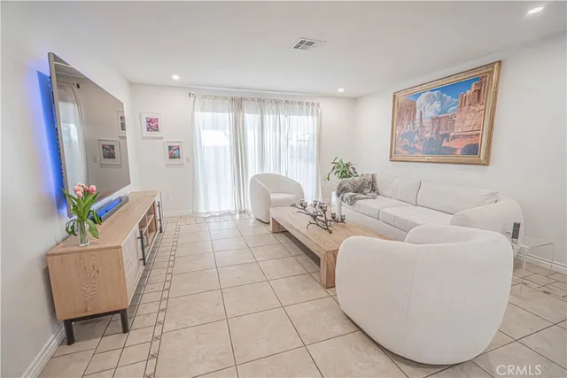 a living room with furniture and a potted plant