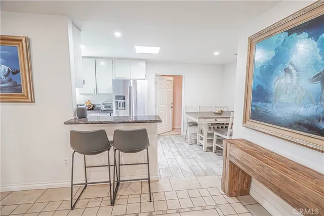 a kitchen with granite countertop a table and chairs