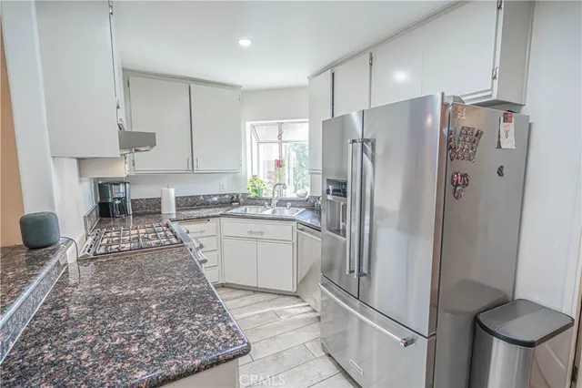 a kitchen with a refrigerator sink and stove