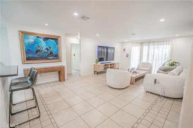a living room with furniture and white walls