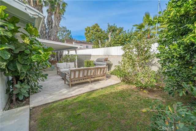 a wooden bench sitting in the middle of a yard