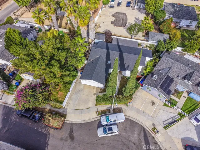 an aerial view of a house with a yard and garden
