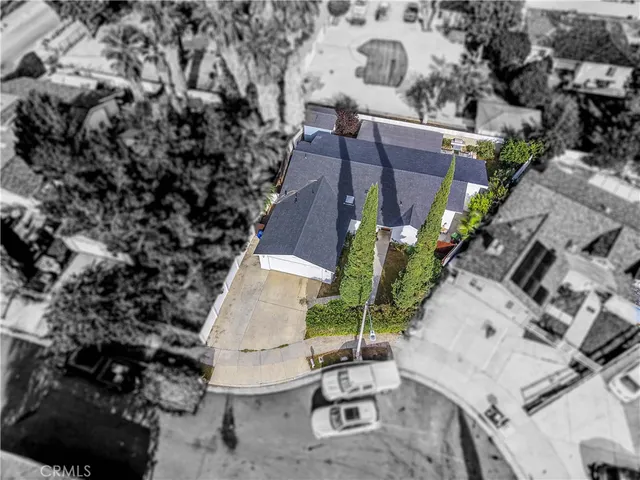an aerial view of a house with a yard and wooden fence