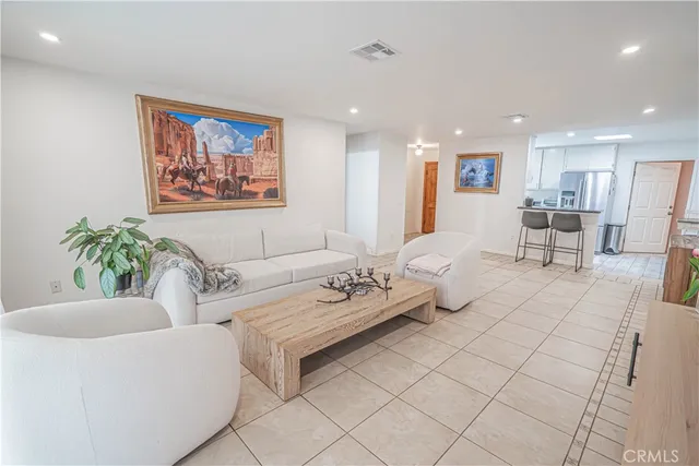 a living room with furniture and a potted plant