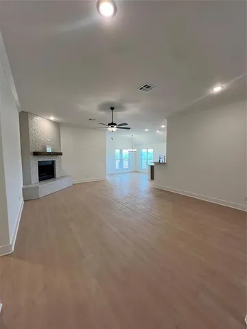 an empty room with a kitchen and a sink