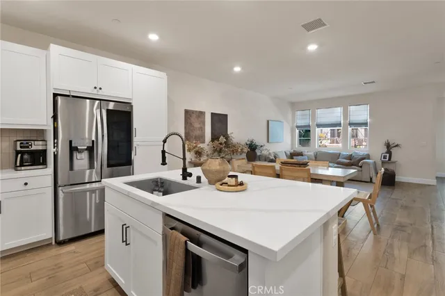 a open kitchen with stainless steel appliances granite countertop a sink a stove and refrigerator